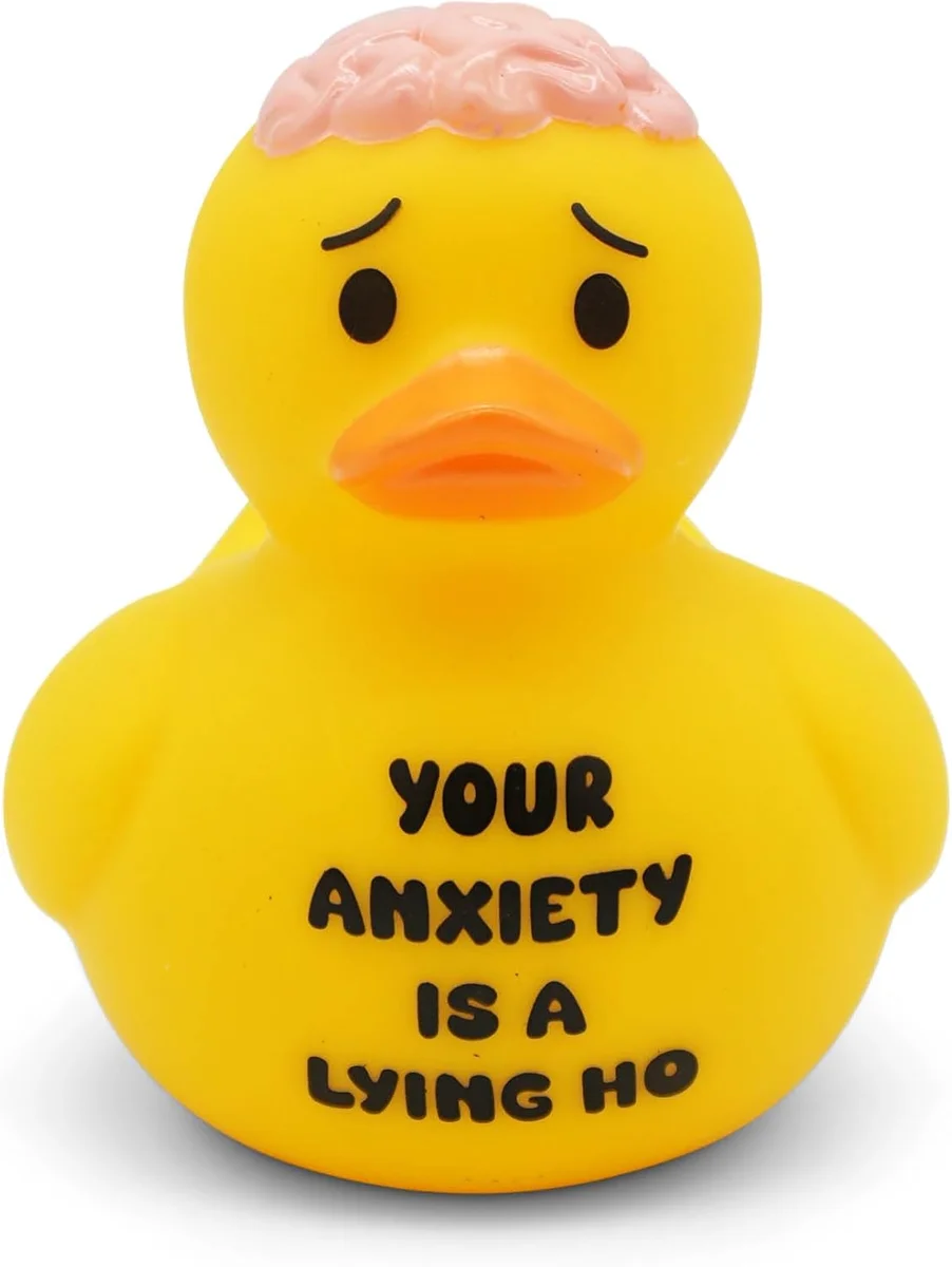 Yellow squeaky rubber bath duck, 4 by 4.5 inches, printed with the slogan "Your Anxiety is a Lying Ho" — a novelty gag-gift duck pitched for bath, desk, or Jeep dashboard