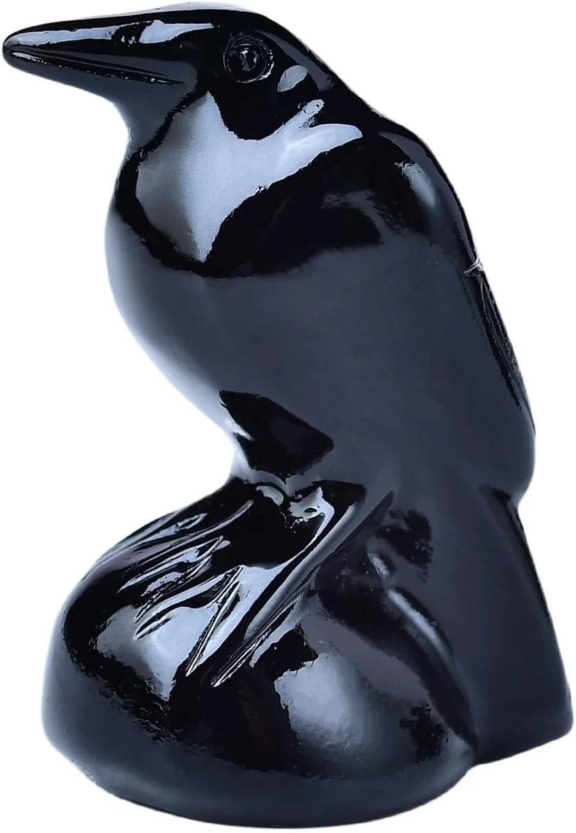 Small handmade natural obsidian raven statue, roughly 2 inches tall, carved from glossy black volcanic stone