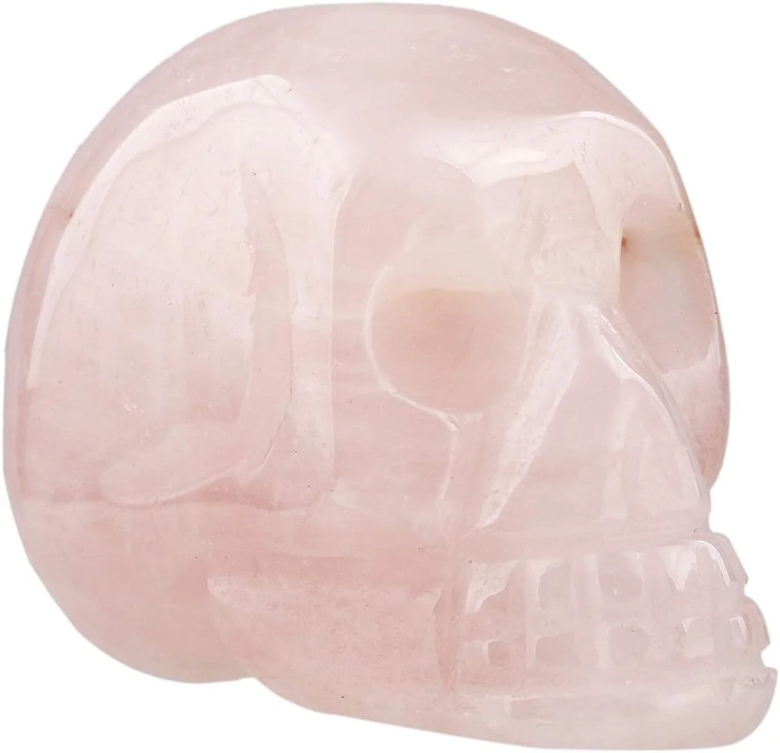 Rose quartz skull figurine, 1.5 inches tall, pale pink translucent crystal carved in human skull form