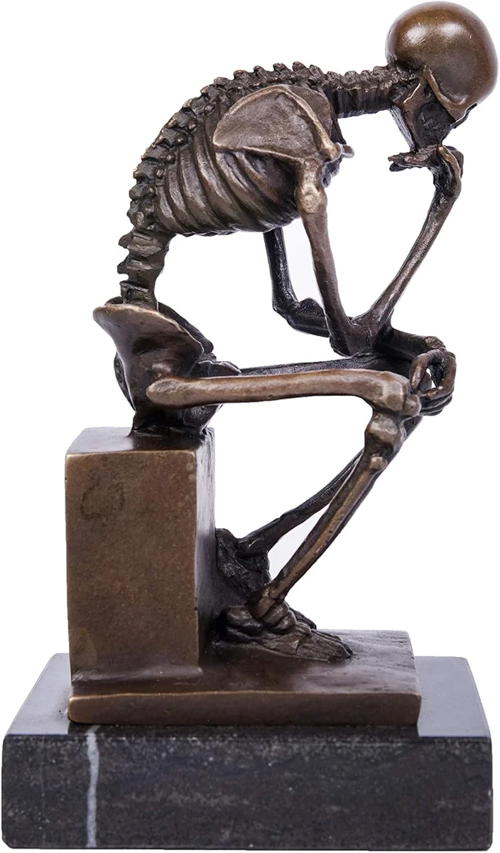 Bronze skeleton statue posed as Rodin's Thinker, seated with chin resting on hand
